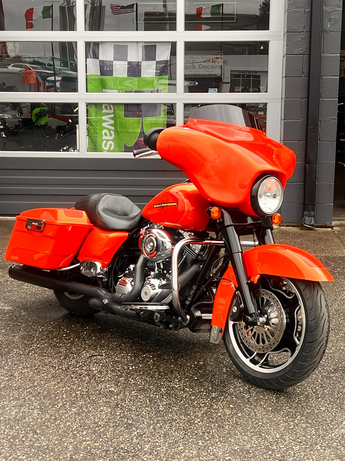 Image of a freshly painted orange Harley Davidson motorcycle at Cooper's Collision in Tacoma, WA